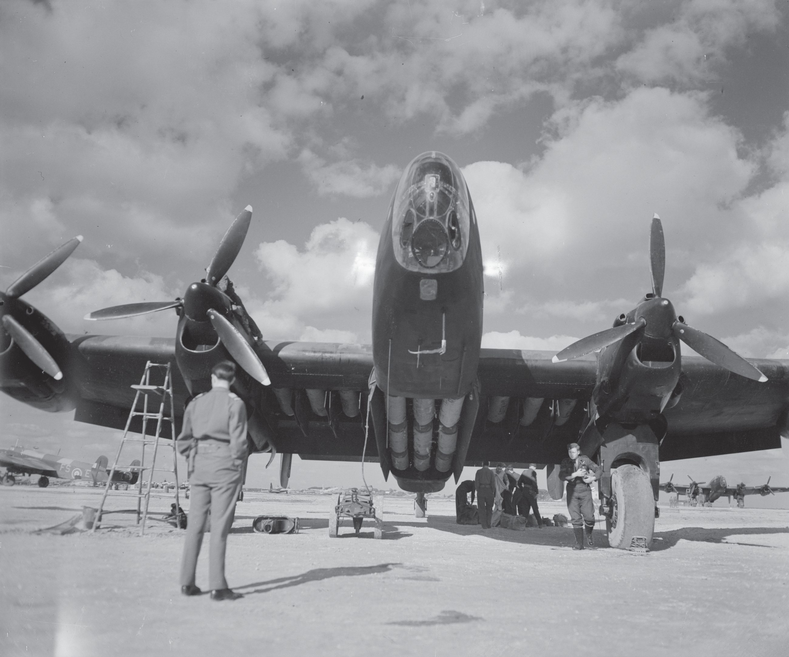 A Halifax of 148 (Special Duties) Squadron in Italy. Aircraft like this one flew the run to Warsaw and back — twelve hours, no fighter escort, at two hundred metres over the drop.