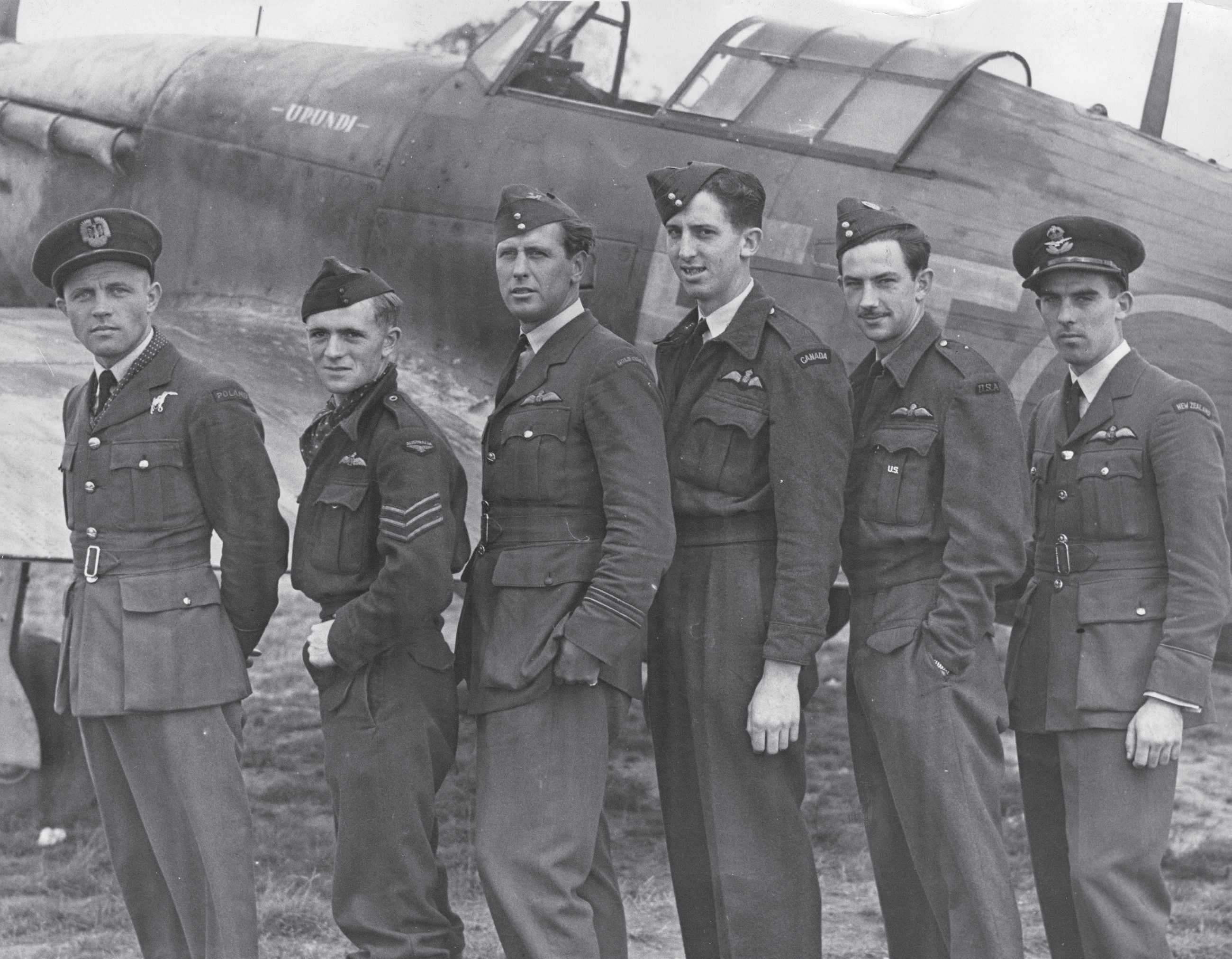 Airmen from all parts of the world who took part in the Dieppe Raid in front of the Hurricane "Urundi" of No. 43 Squadron at RAF Tangmere, 20 August 1942. From left to right - P/O Andrzej Malarowski of No. 317 Polish Fighter Squadron, pilots from Australia, Gold Coast, Canada, USA and New Zealand.