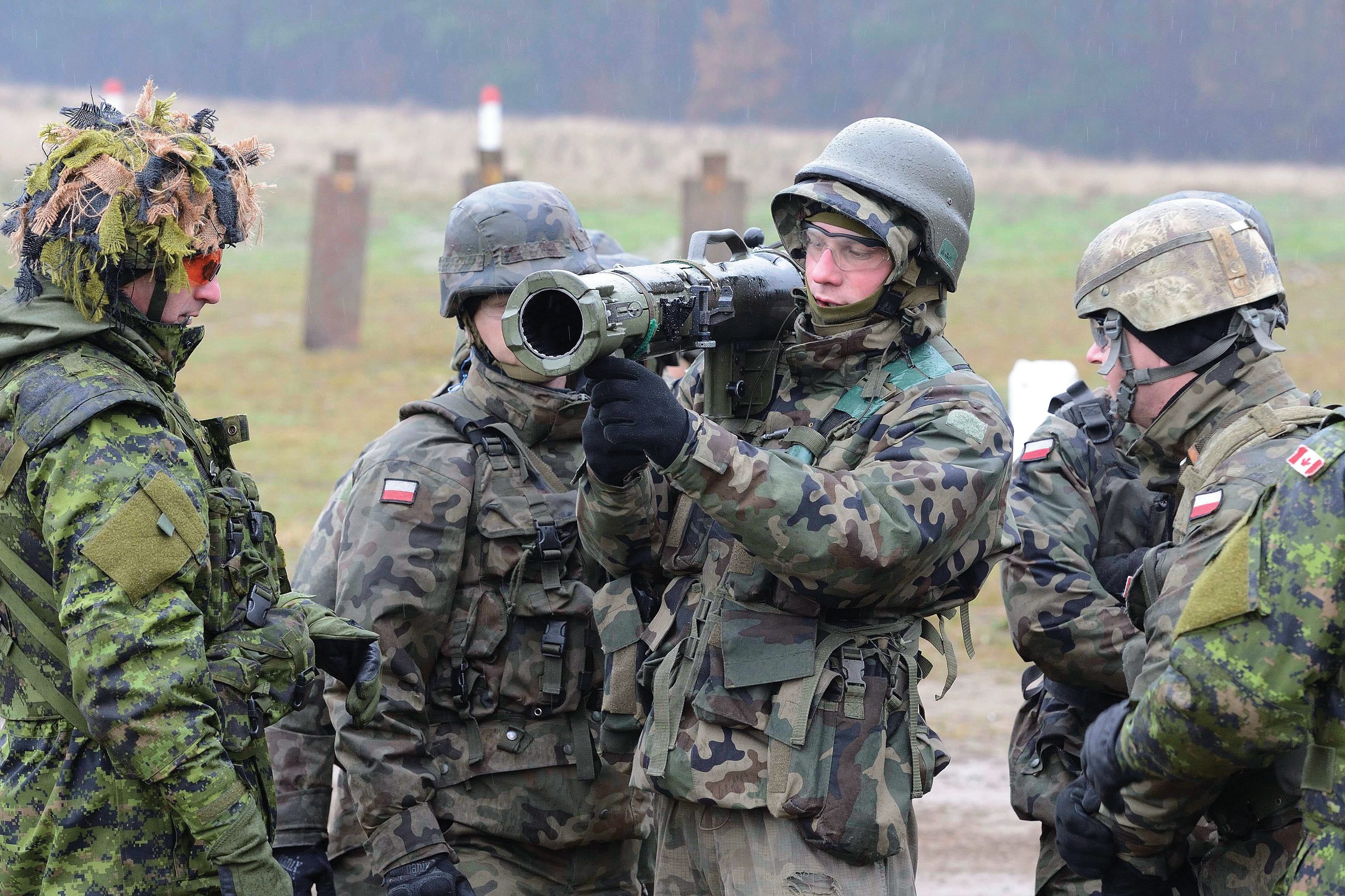 Members of Oscar Company Group, 3rd Battalion, The Royal Canadian Regiment and Polish soldiers practice drills on the 84 mm Carl Gustaf at the range during Operation REASSURANCE in Central and Eastern Europe on November 19, 2014.